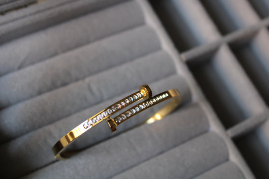 Gold-tone stainless steel bracelet with cubic zirconia accents. Anti-tarnish, hypoallergenic, and perfect for any occasion. Shop premium fashion jewelry at FashNotch!